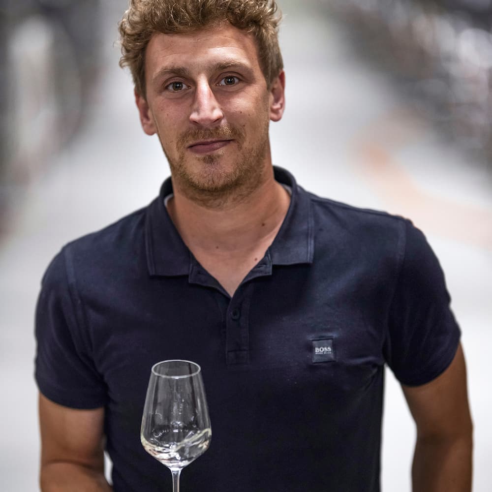 Clean Slate winemaker Dominik Meyer holding glass of wine